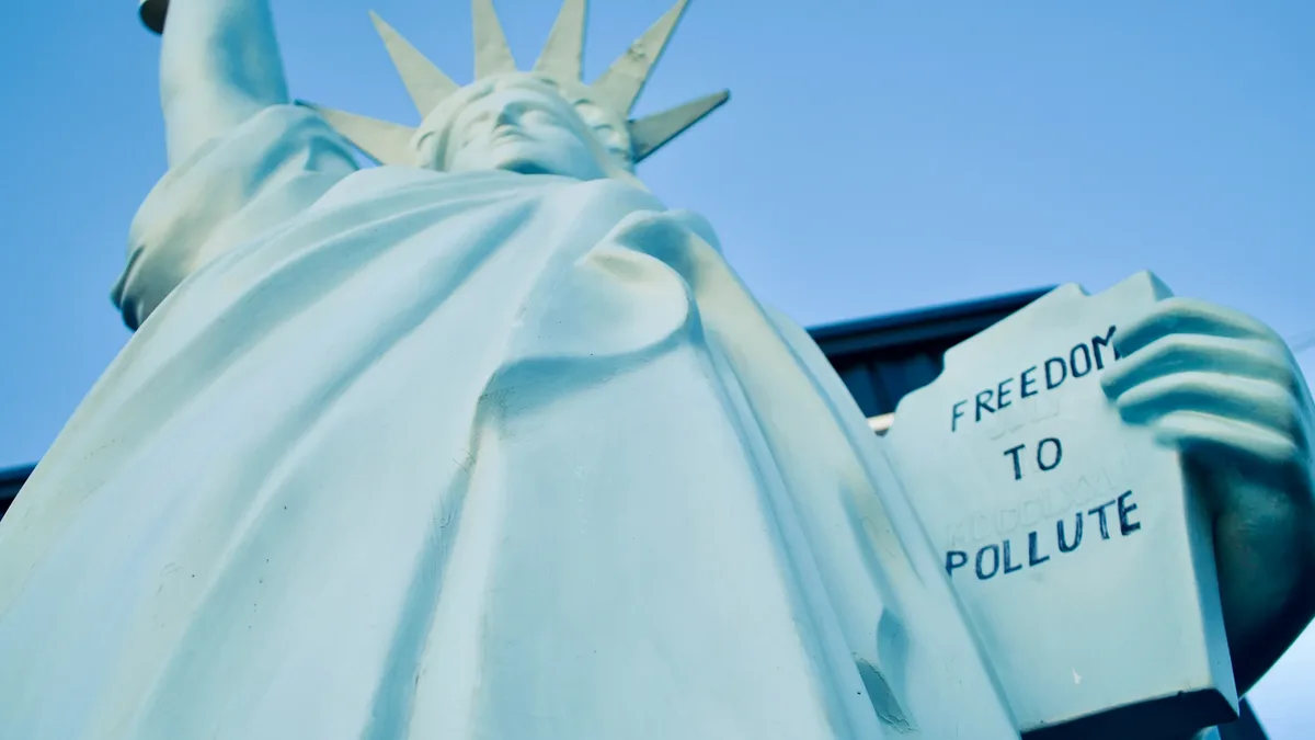The Statue of Liberty with a sign that reads "FREEDOM TO POLLUTE" held by the statue's hand.